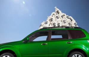 $ money bags piled on car roof